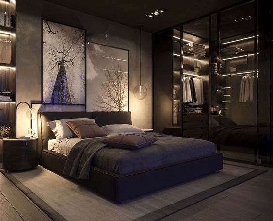 Phòng ngủ của vợ chồng gia chủ được bài trí theo phong cách tối giản với gam màu tối cá tính. Hệ thống đèn chiếu sáng lắp đặt khéo léo giúp tôn lên vẻ đẹp của nội thất là phụ kiện trang trí như tranh tường đầu giường.